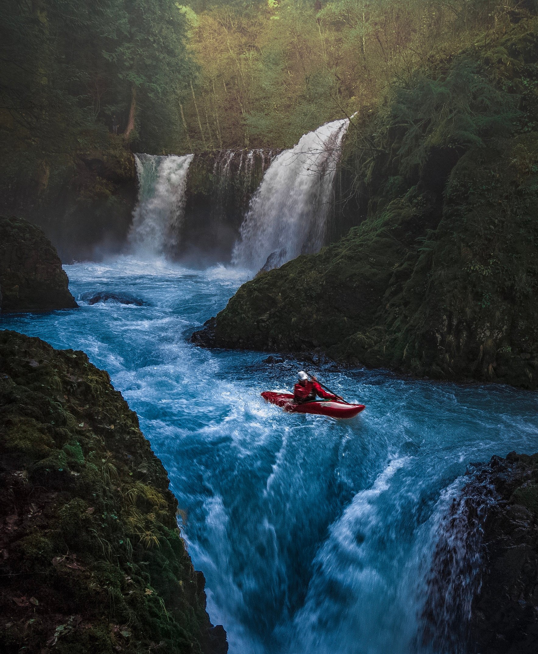 Person on Watercraft Near Waterfall