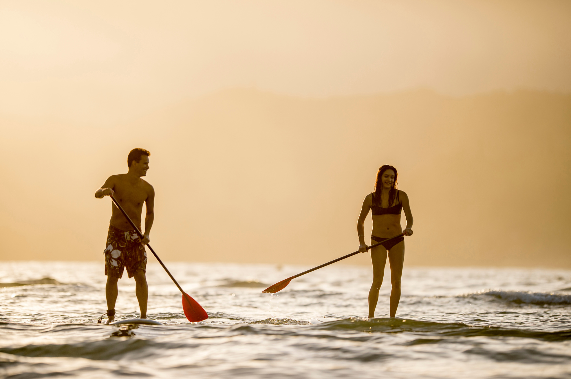 Couple stand up paddleboarding SUP